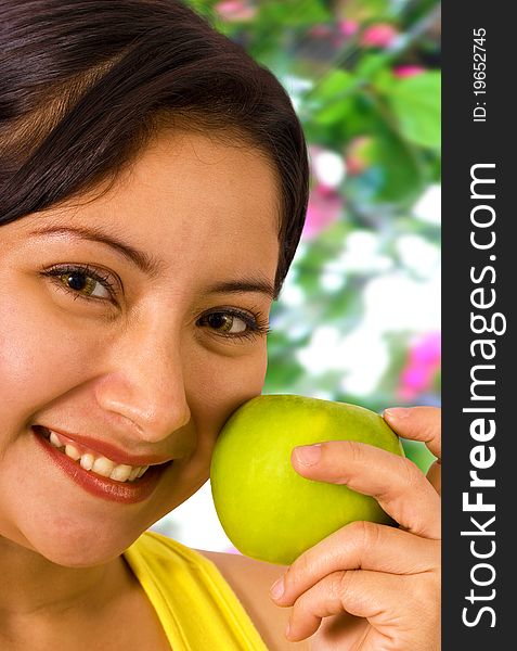 Young Lady Smiling In The Garden About To Eat An Apple. Young Lady Smiling In The Garden About To Eat An Apple