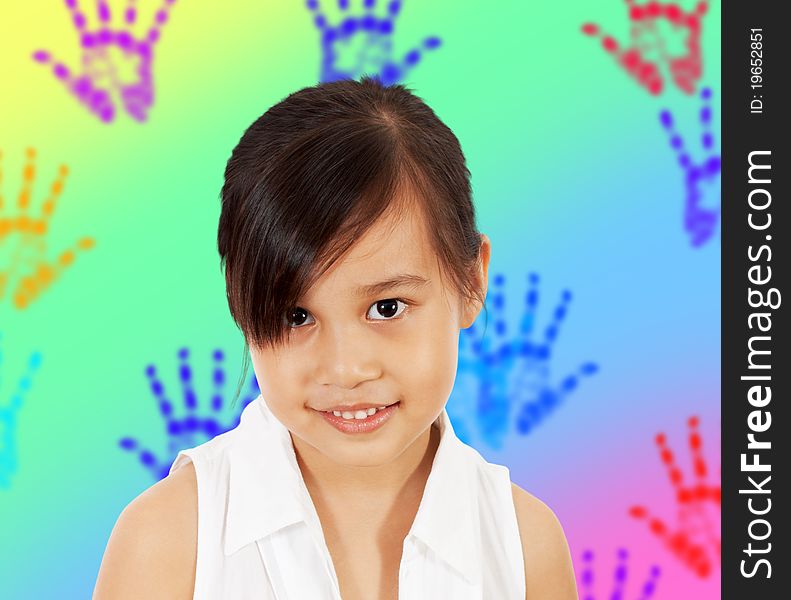 A Shy Young Girl In Her Play Room With Multicolored Hand Prints On The Wall