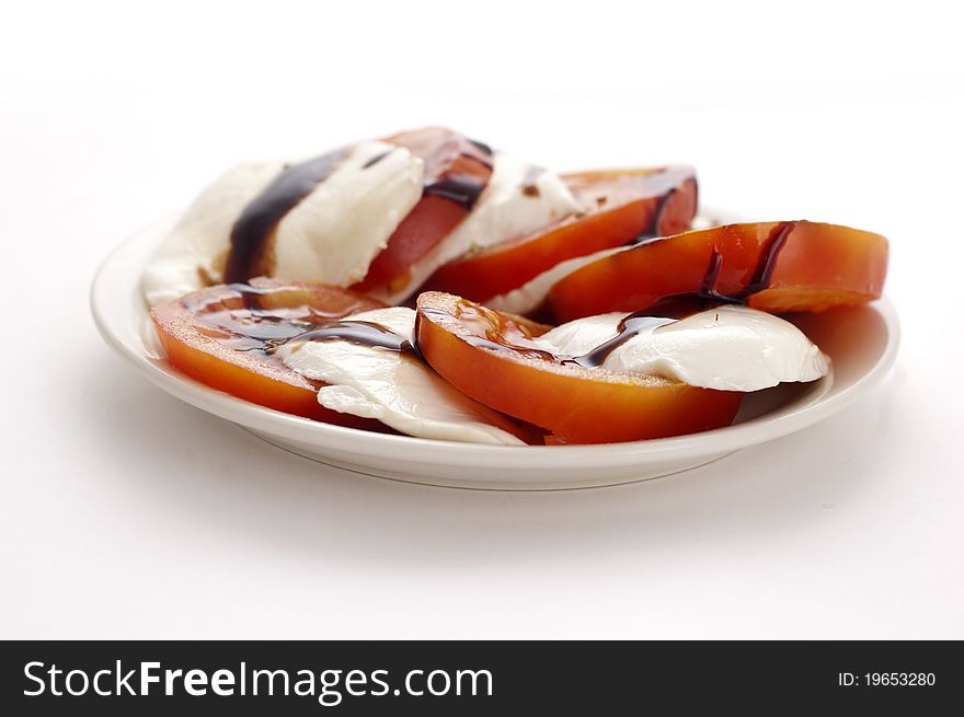 Mozarella and tomatoes isolated on white background. Mozarella and tomatoes isolated on white background