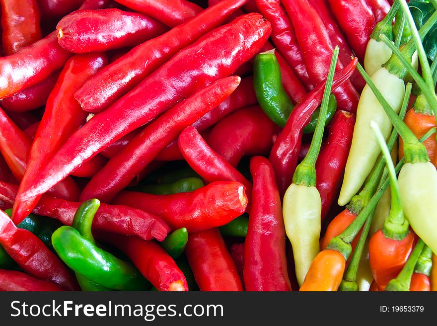 Background of closeup colorful chilies. Background of closeup colorful chilies.