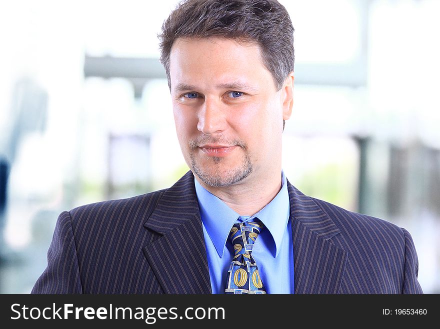 Closeup portrait of a joyful young business man smiling