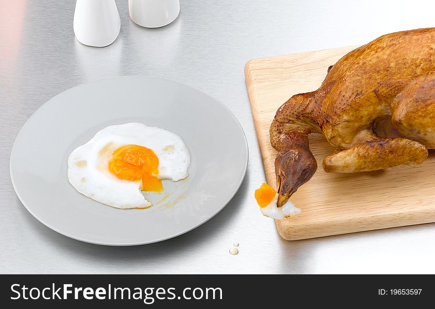 Conceptual image of the died chicken toasted but still hungry, the image isolated in the kitchen . Conceptual image of the died chicken toasted but still hungry, the image isolated in the kitchen