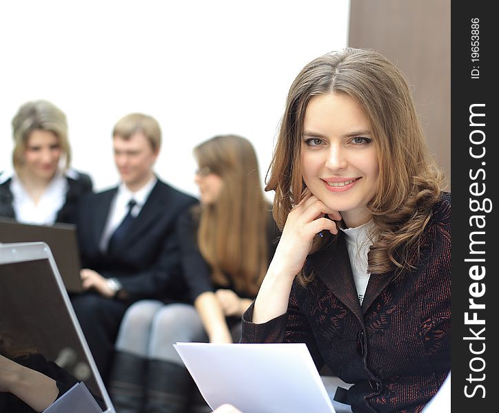 Portrait of a smart young businesswoman with people at the back