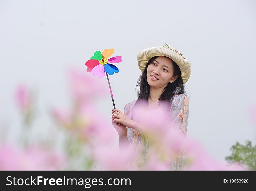 A girl in field with pinwheel in hand