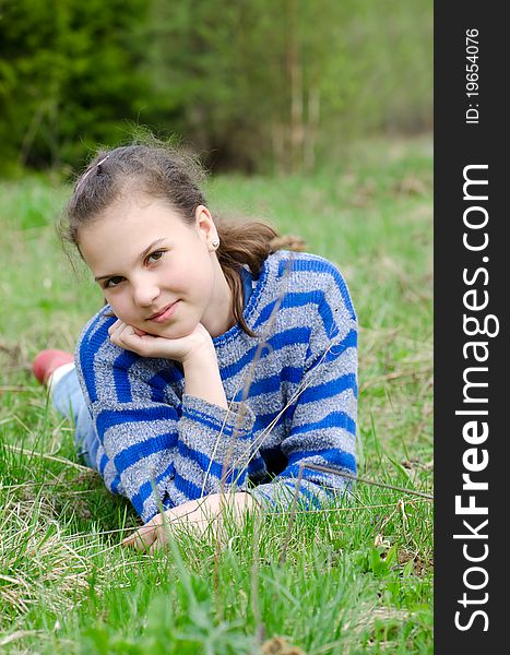 Portrait of the girl Against green wood