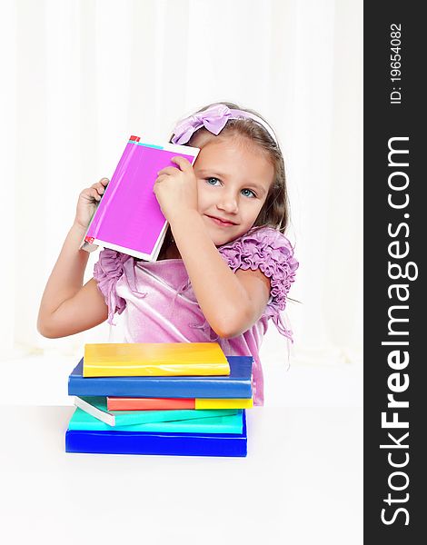 Beautiful little girl playing with books. Beautiful little girl playing with books