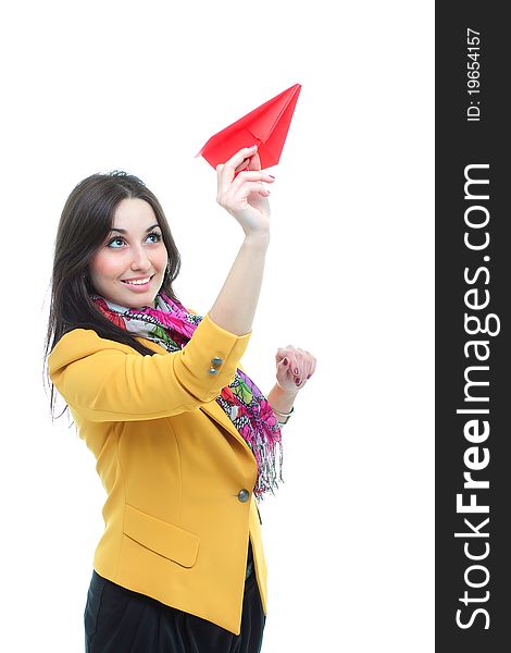 Young charming brunette launching a paper airplan against white background
