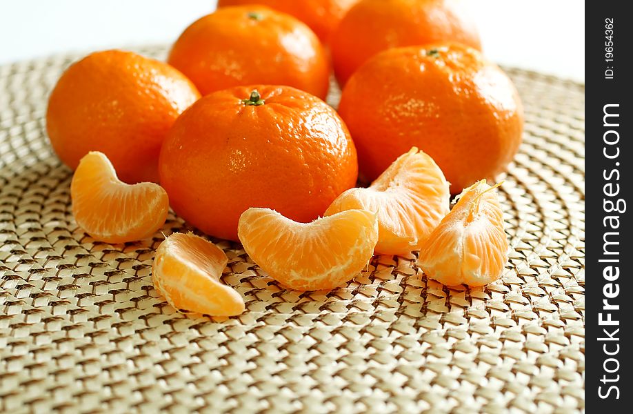 Fresh tangerines on beige background