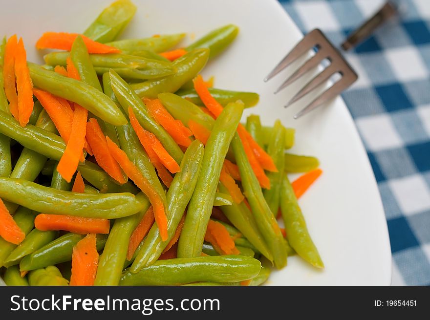 Sliced long beans and carrots prepared as food ingredients. Sliced long beans and carrots prepared as food ingredients.