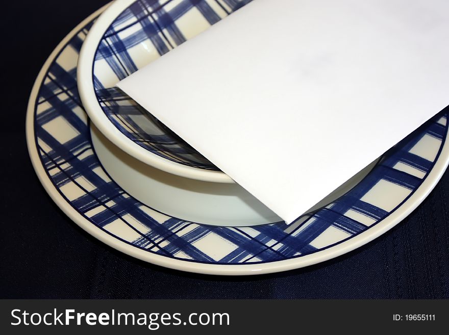 Write your message on this white envelope placed on colorful plate and bowl. Write your message on this white envelope placed on colorful plate and bowl