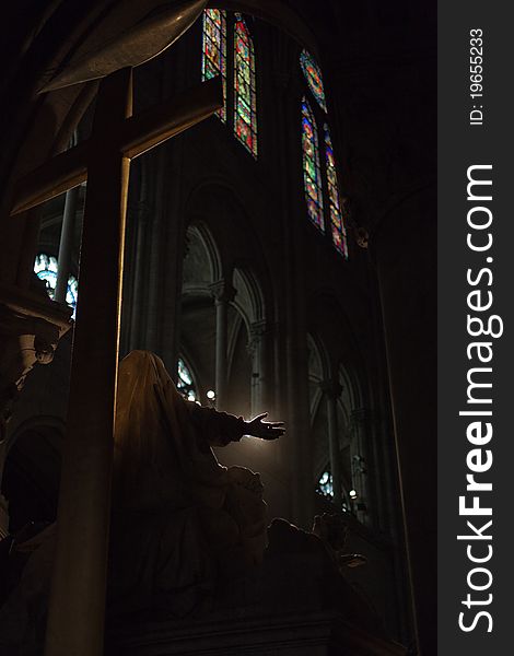 Silhouetted statue inside Notre Dame de Paris. Silhouetted statue inside Notre Dame de Paris