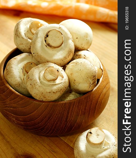 Fresh mushroom in wooden bowl on table. Fresh mushroom in wooden bowl on table