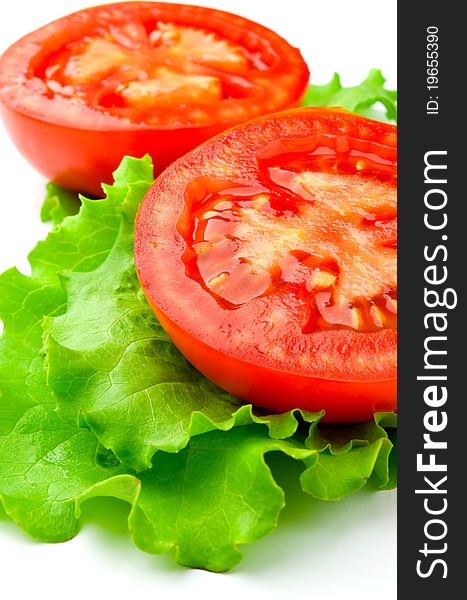 Red tomatoes and lettuce on a white background