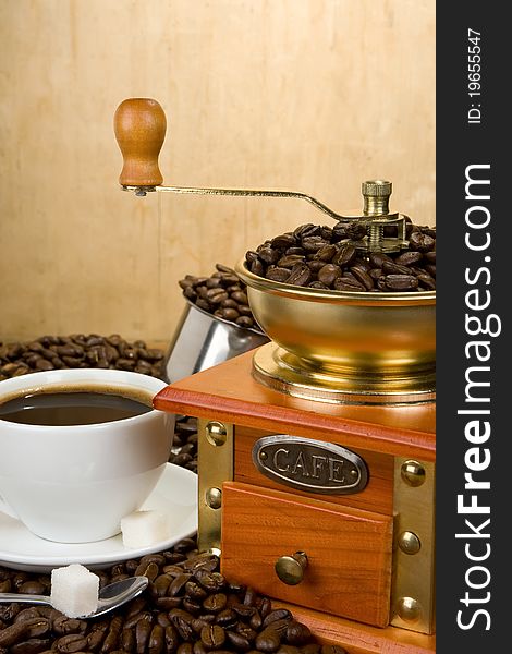 Coffee Beans, Cup And Grinder On Wood