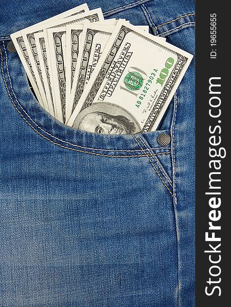 Vertical image of dollars in jeans pocket