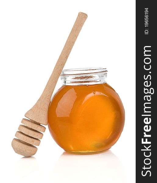 Glass pot full of honey and stick isolated on white background. Glass pot full of honey and stick isolated on white background