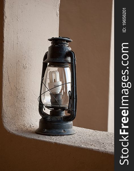 An antique lantern shot with a modern lamp