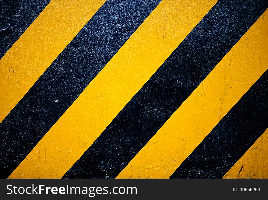 Pattern yellow and black is sign warning something on the road.