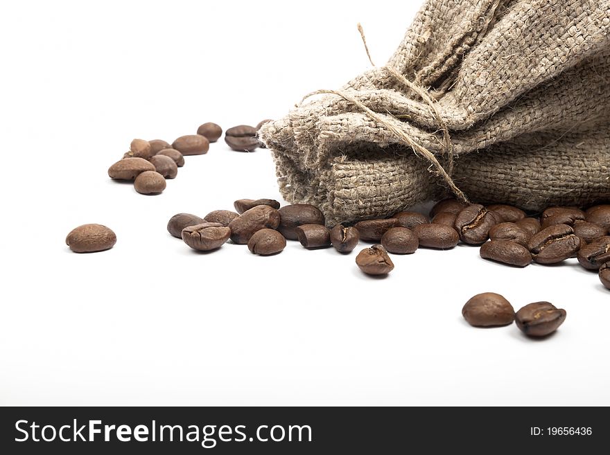 Coffee beans spilled on a white background