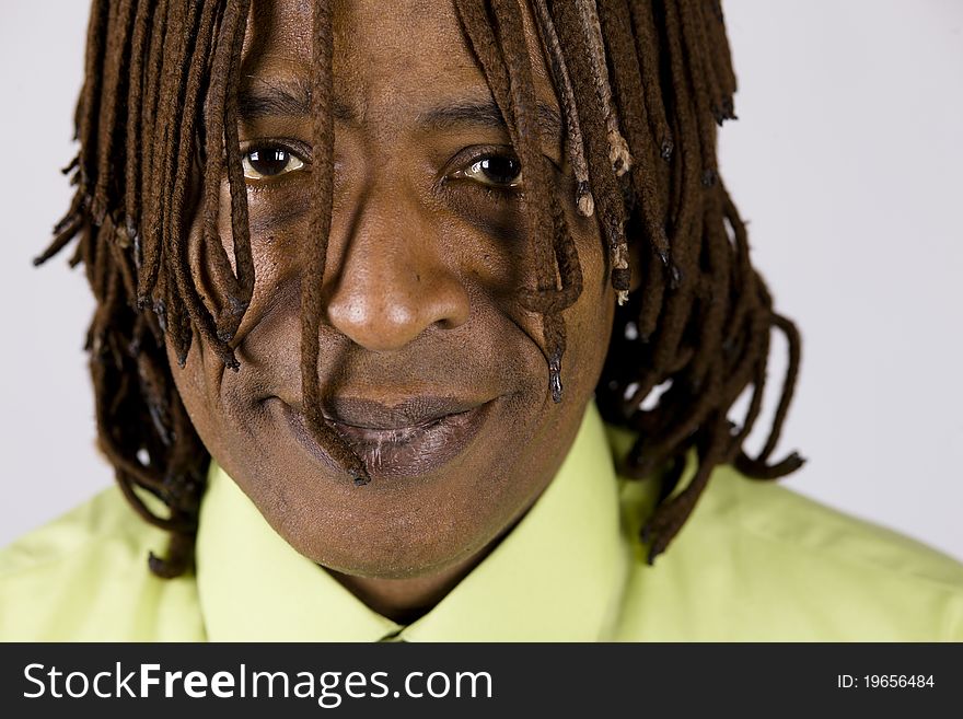 Closeup Portrait of an African American Businessman with Dreadlocks Hanging in front of His Eyes. Closeup Portrait of an African American Businessman with Dreadlocks Hanging in front of His Eyes