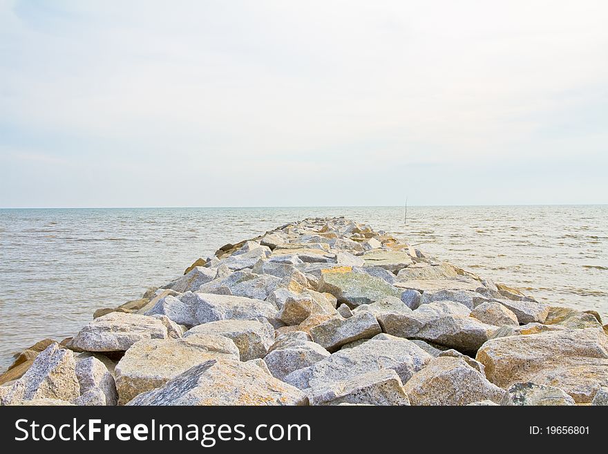 Bridge of Huge Sea Stone Embankment at seaside during evening