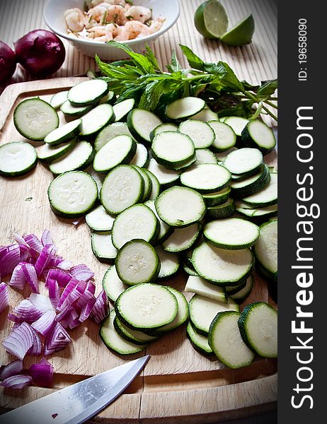 Food preparation: courgettes and onions on a board