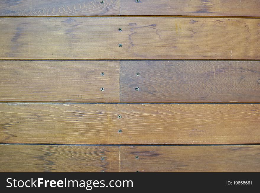 A wood wall has texture and detail as a background image. A wood wall has texture and detail as a background image.