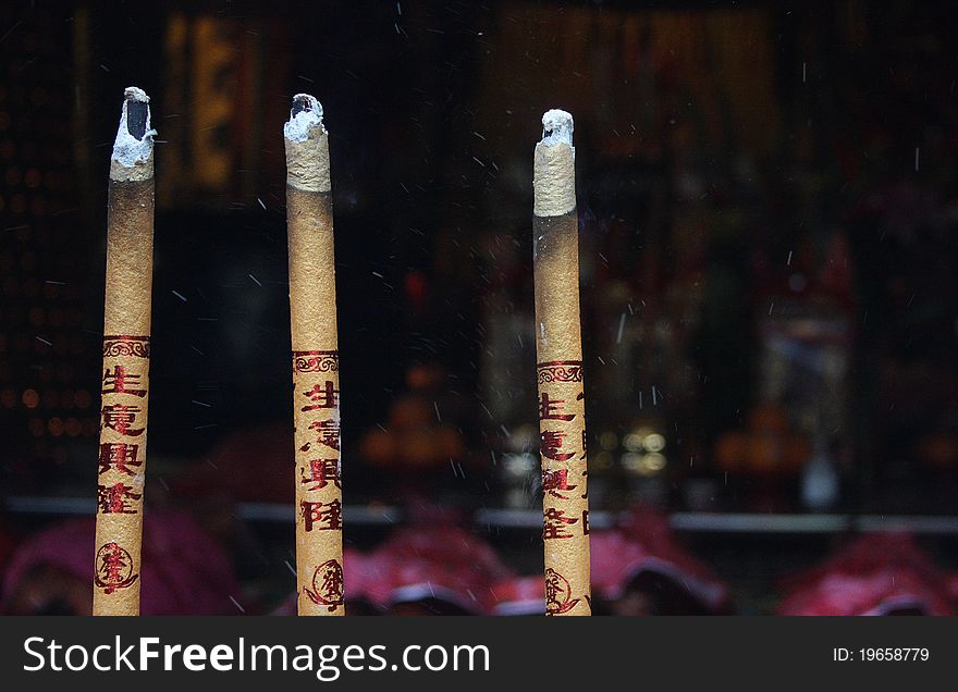 Incense burining in a buddhist temple of Macau, China. Incense burining in a buddhist temple of Macau, China.