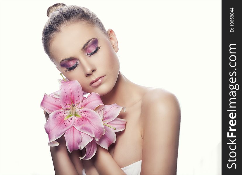 Portrait of a blond beauty with flowers on the white background. Portrait of a blond beauty with flowers on the white background