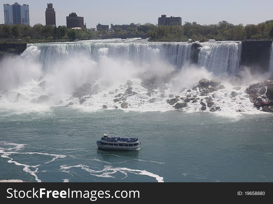 Niafara falls,american,view from canada on the river with a boat and falls. Niafara falls,american,view from canada on the river with a boat and falls