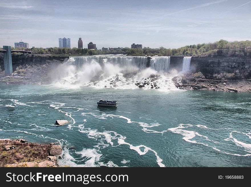 View to american niagara falls from canada,with a boat on the river