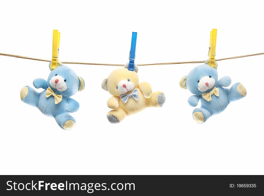 Teddy bears hanging on the clothesline.
isolated on white background. Teddy bears hanging on the clothesline.
isolated on white background
