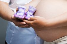 Pregnant Woman Holding Pair Of Shoes Stock Photo Pregnant Woman Holding Pair Of Shoes Stock Photo