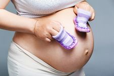 Pregnant Woman Holding Pair Of Shoes Stock Photography Pregnant Woman Holding Pair Of Shoes Stock Photography