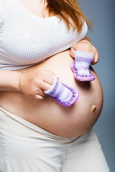 Pregnant Woman Holding Pair Of Shoes Royalty Free Stock Images Pregnant Woman Holding Pair Of Shoes Royalty Free Stock Images