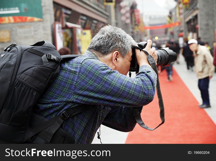 A photographer is shooting the streets of ancient China. A photographer is shooting the streets of ancient China.