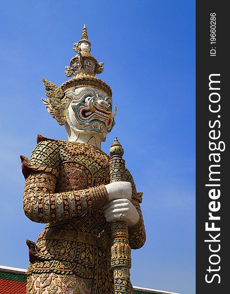 Demon statue standing guard at the Temple of the Emerald Buddha in Bangkok, Thailand. Demon statue standing guard at the Temple of the Emerald Buddha in Bangkok, Thailand.