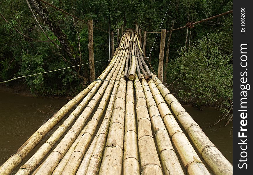 Hanging bamboo bridge over river