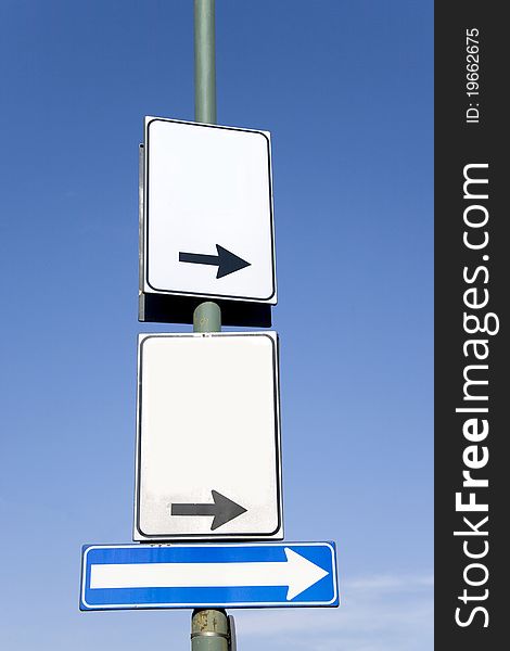 Blank turn right road sign against the sky