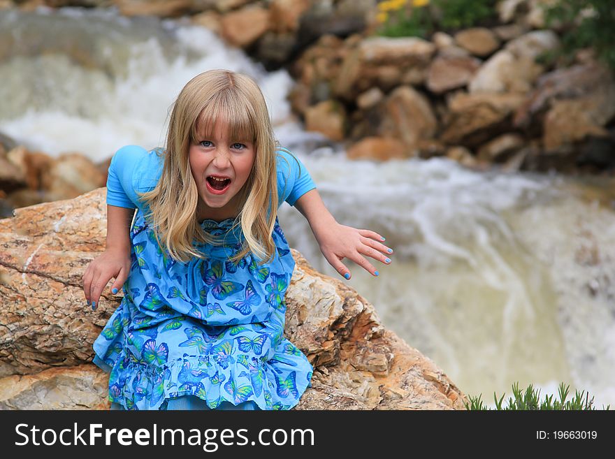 Cute young girl pulls a scary funny face