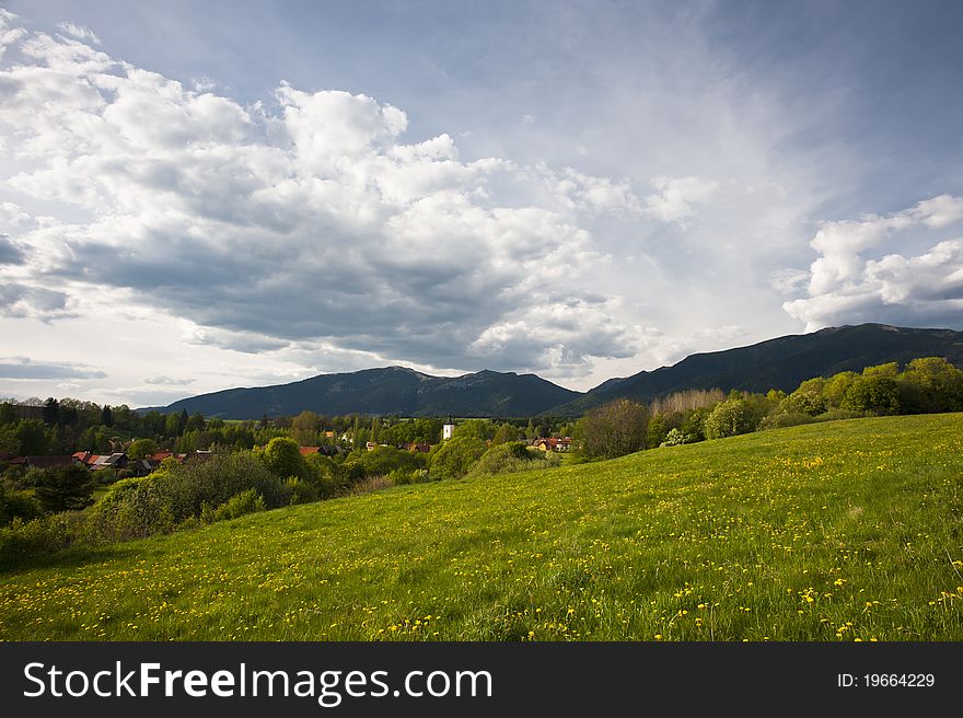 A scenery with village and meadows in spring. A scenery with village and meadows in spring