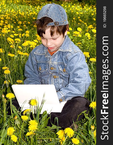 In the photo presented the boy with the netbooks on the nature. In the photo presented the boy with the netbooks on the nature