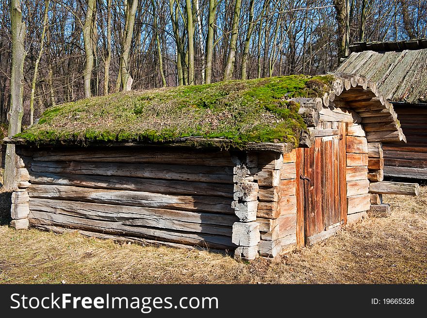 Old wooden house (warehouse) with moss on the roof. Old wooden house (warehouse) with moss on the roof