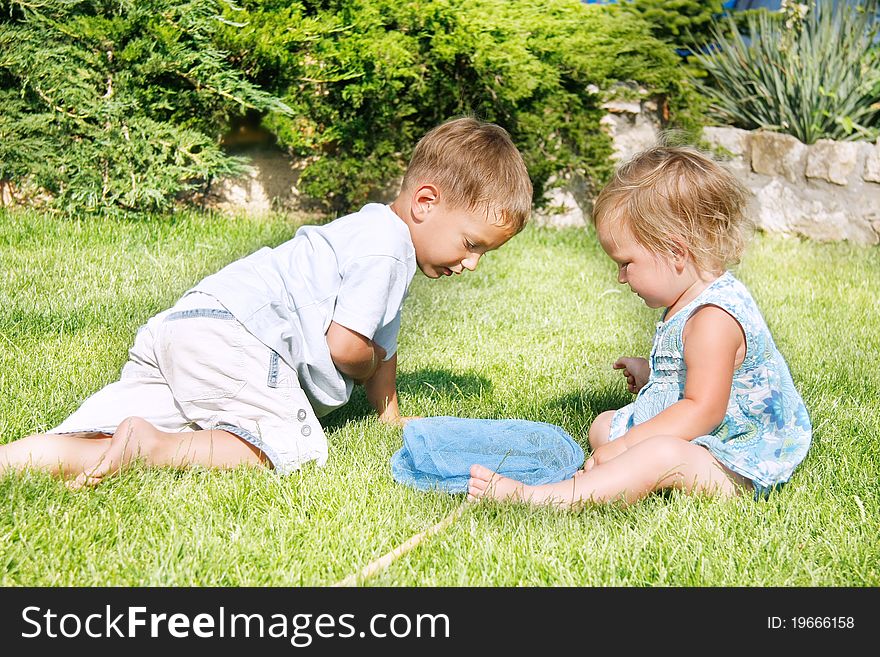 Two children playing on grass. Two children playing on grass