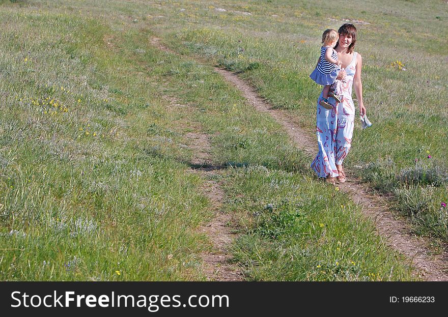 Mother And Child Walking By Road