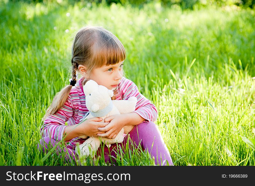 A sad little girl alone on outside the home