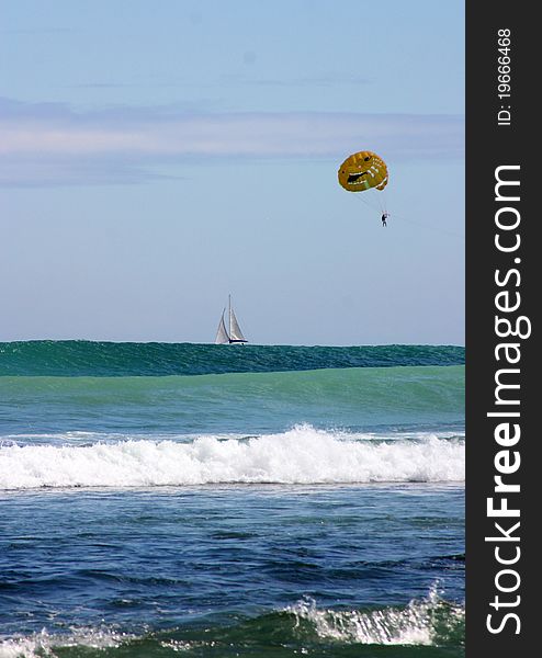 Parasailing over a sailing boat in the Indian Ocean. Parasailing over a sailing boat in the Indian Ocean