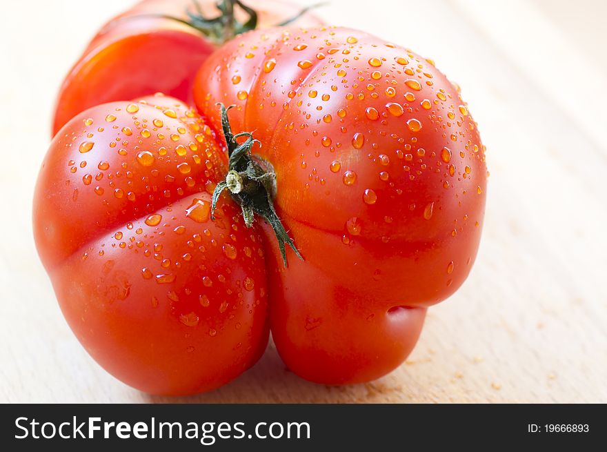 Close-up of tomato with water drops and a rare form. Close-up of tomato with water drops and a rare form