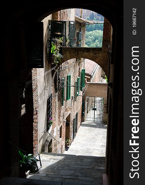 Alley in the historic center of Siena in Tuscany. Alley in the historic center of Siena in Tuscany