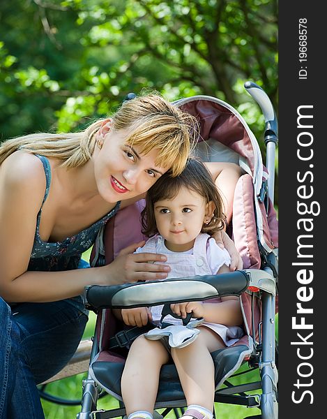 Mother with baby carriage in park